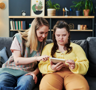 woman and girl looking in tablet