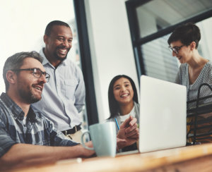 Group of people looking in laptop