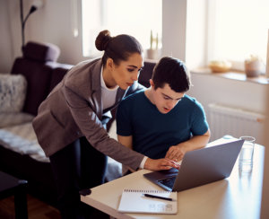 man and woman using laptop