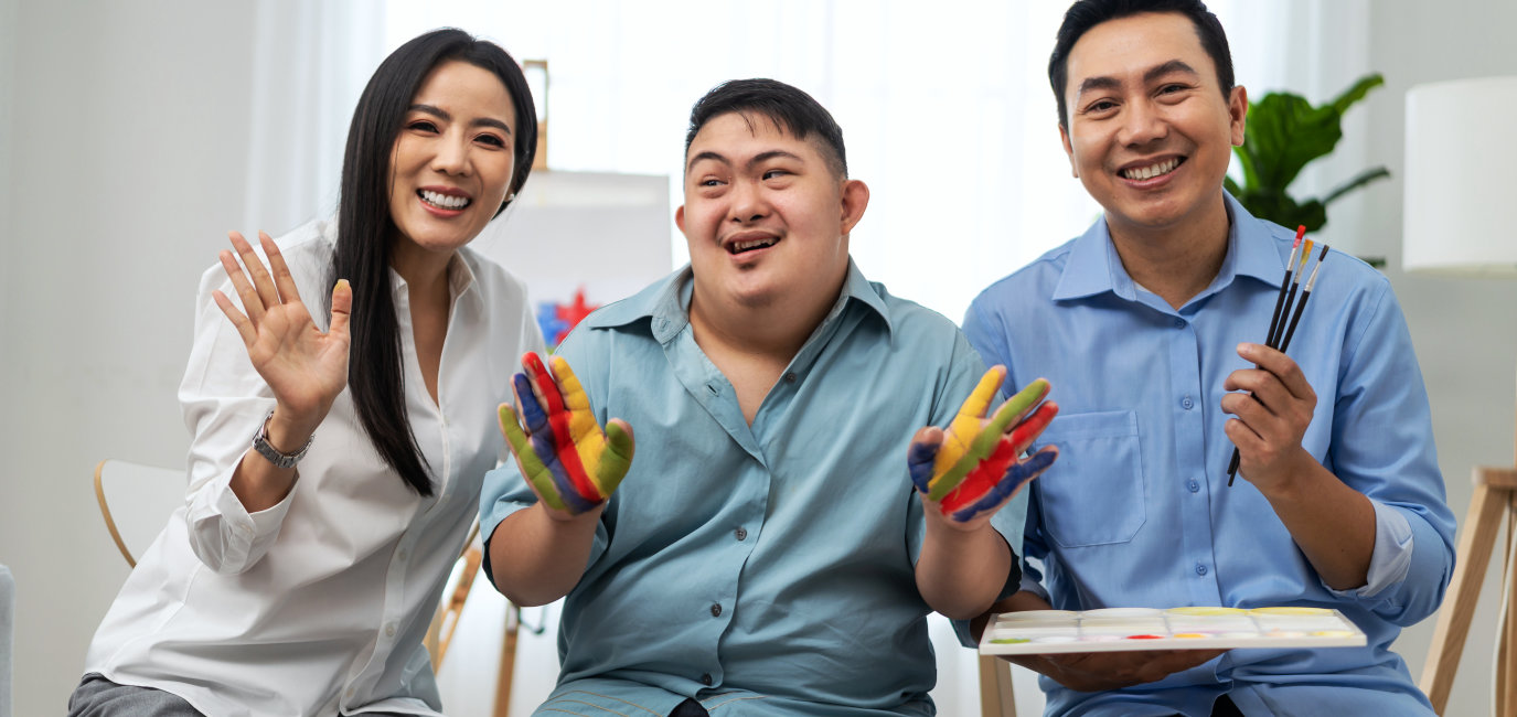 Group of people sitting with paint in hands