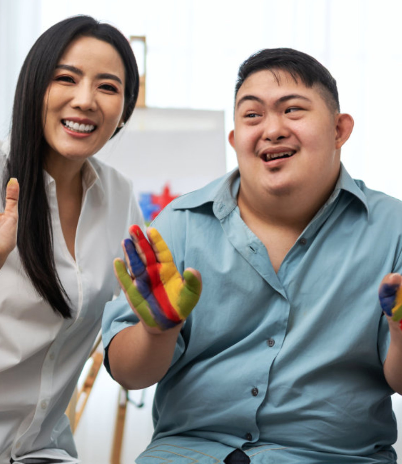 Group of people sitting with paint in hands