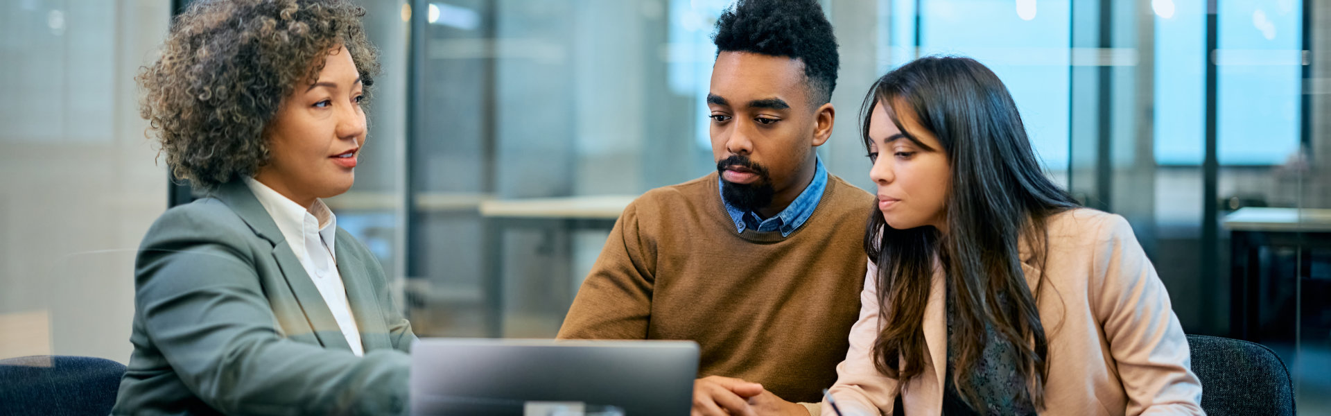 man and woman looking in laptop