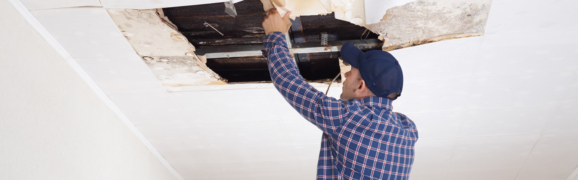 man fixing ceiling