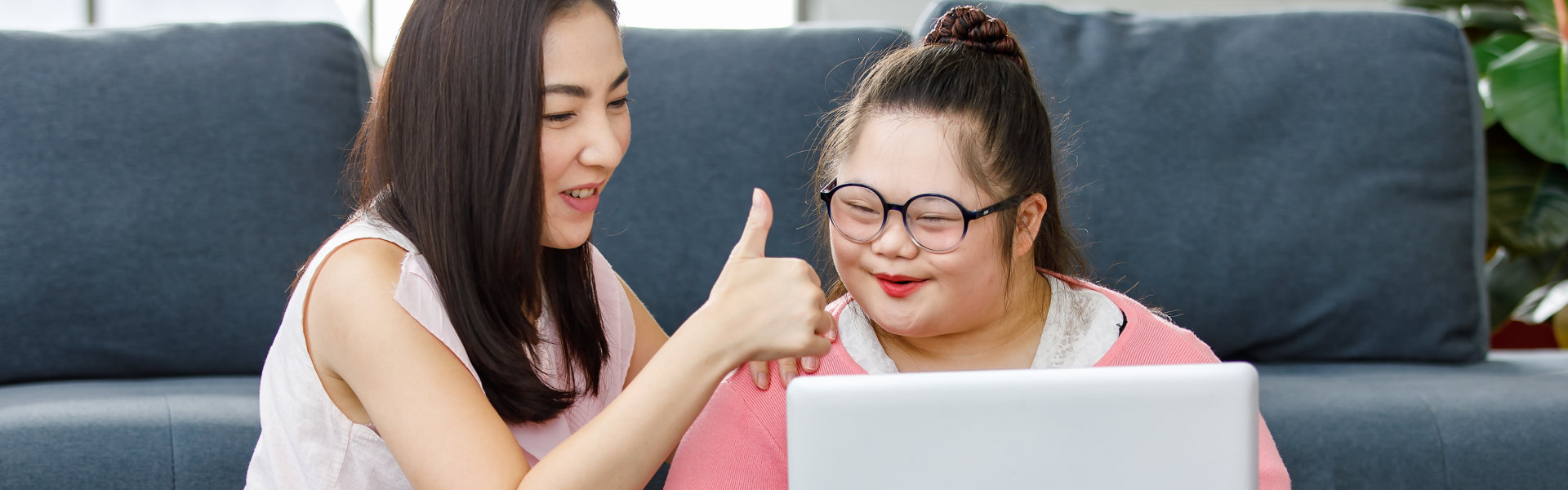 woman and gild looking in laptop